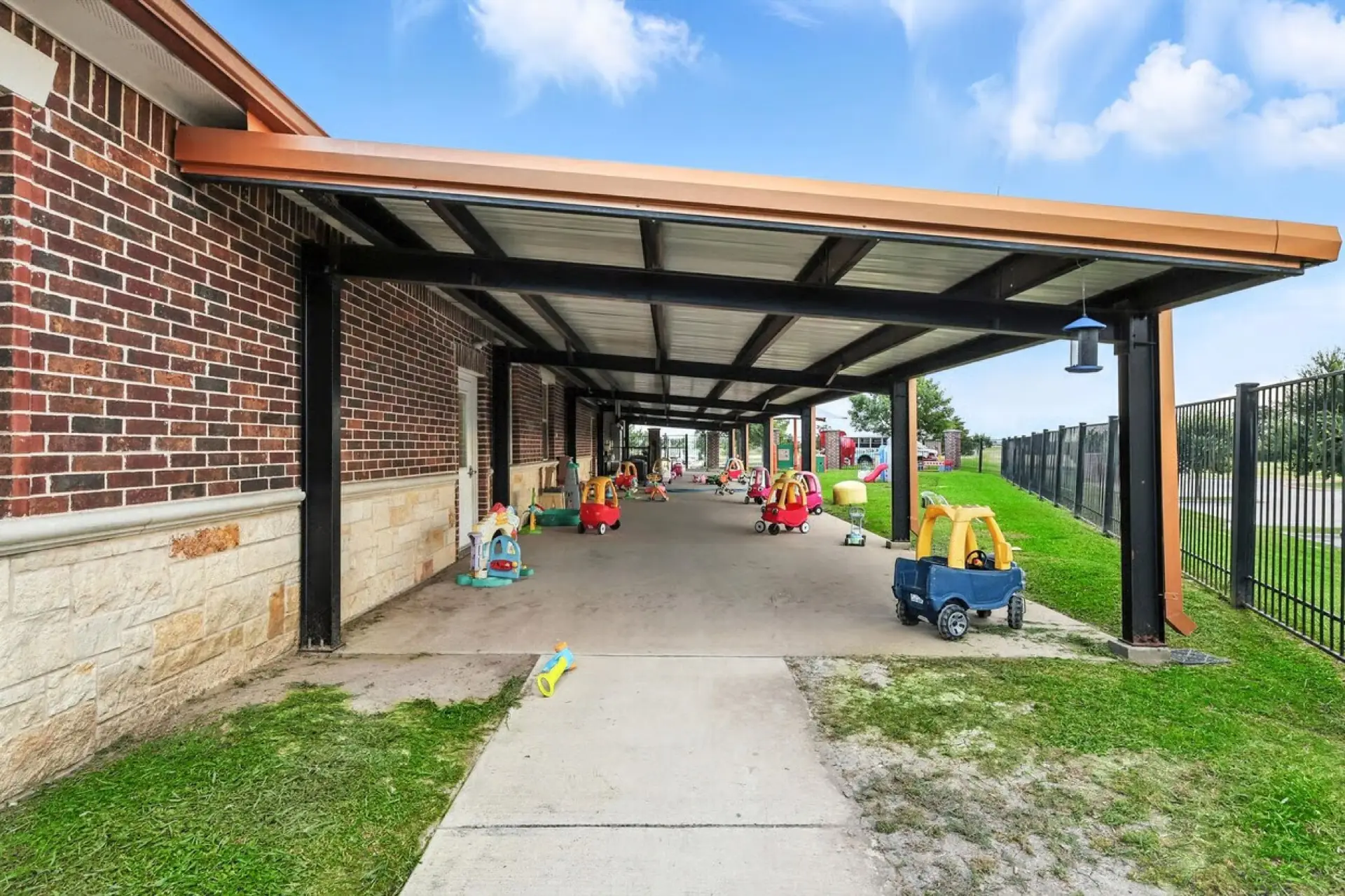 Covered walkway lined with ride-on toys
