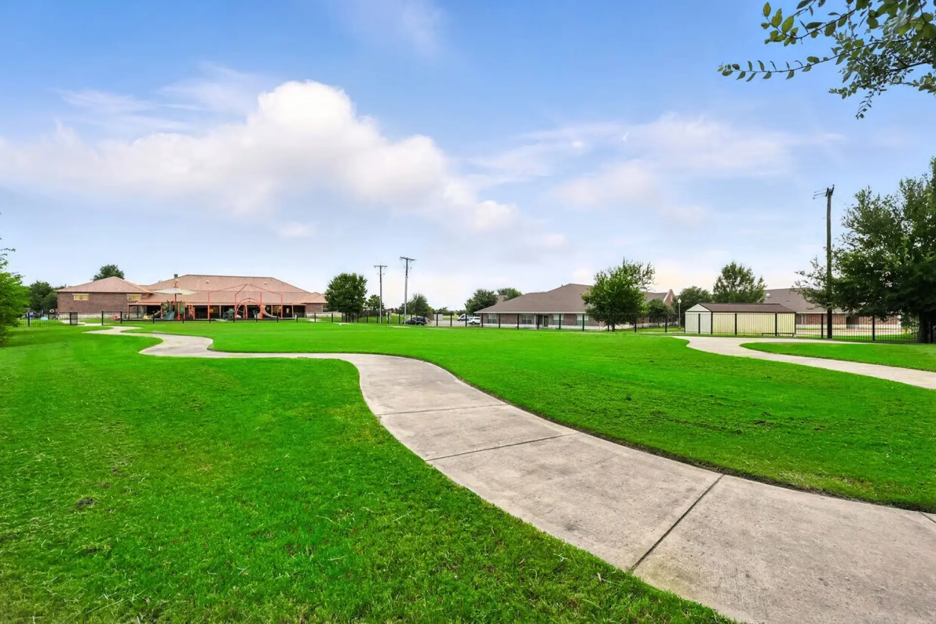 Wide green lawn with walking paths