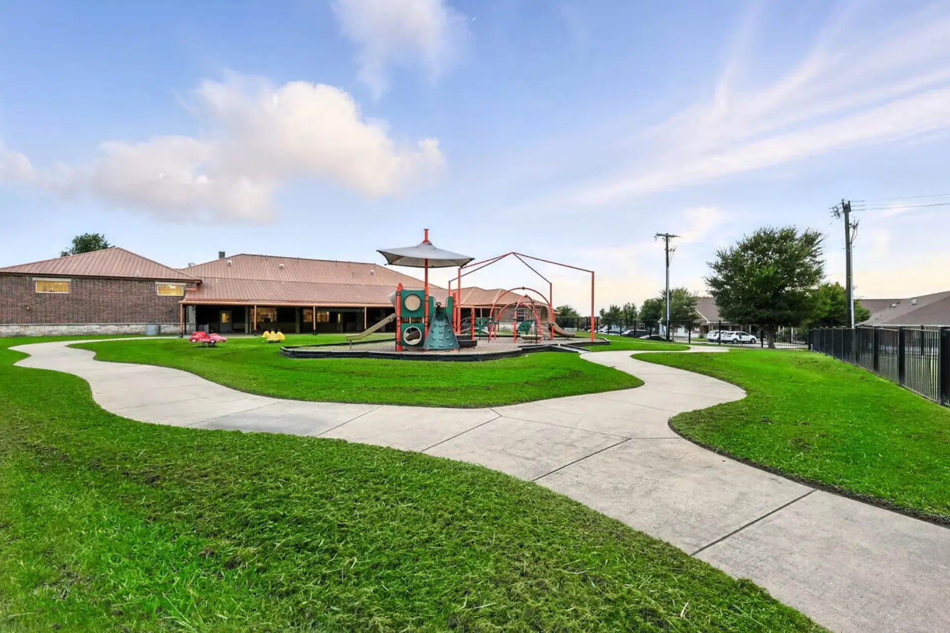 Playground with shade structures beside the building